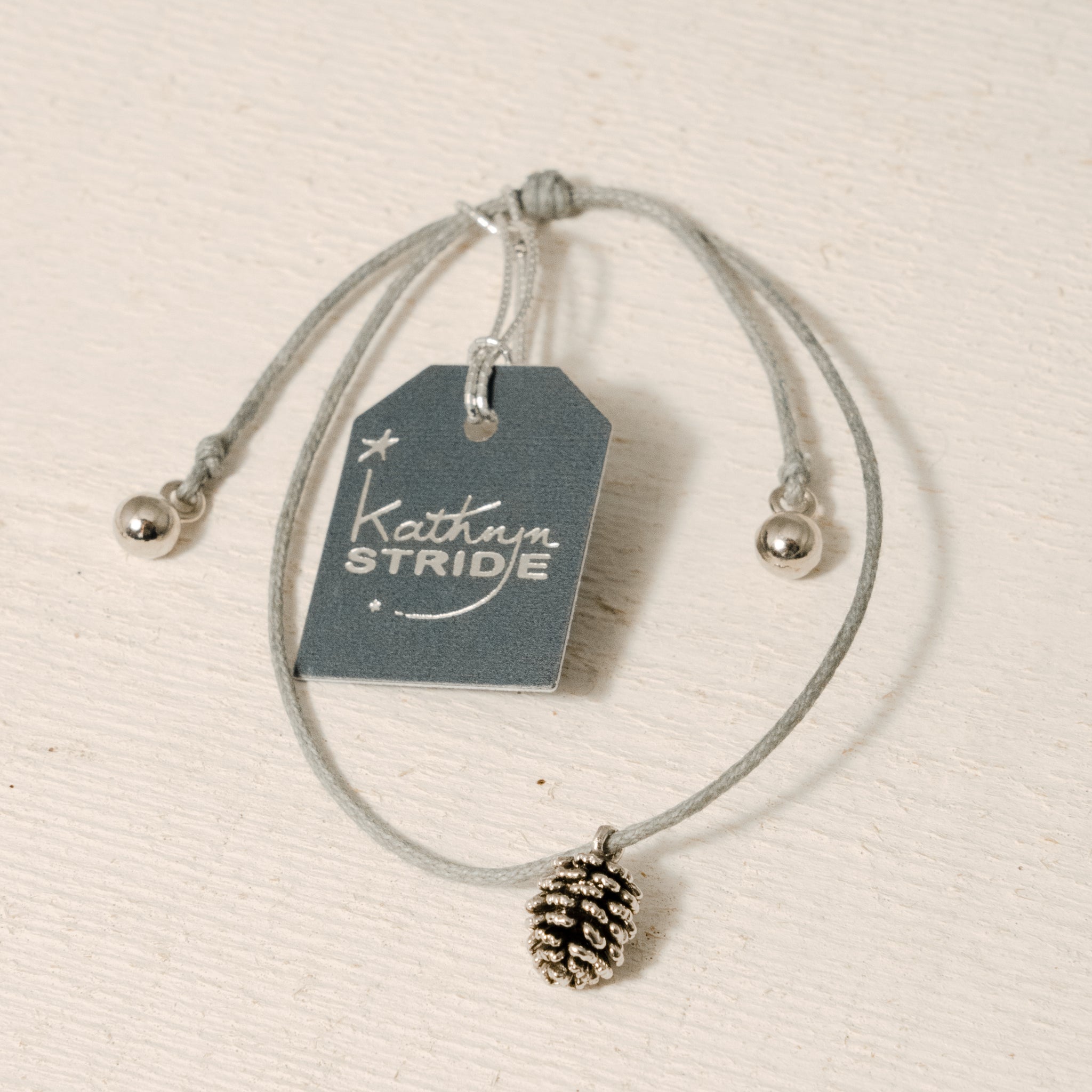Grey Cord Bracelet with Silver Pine Cone metal charm